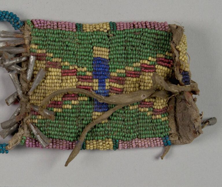 A central plains strike-a-light-bag with the middle green beads used as a background colour.