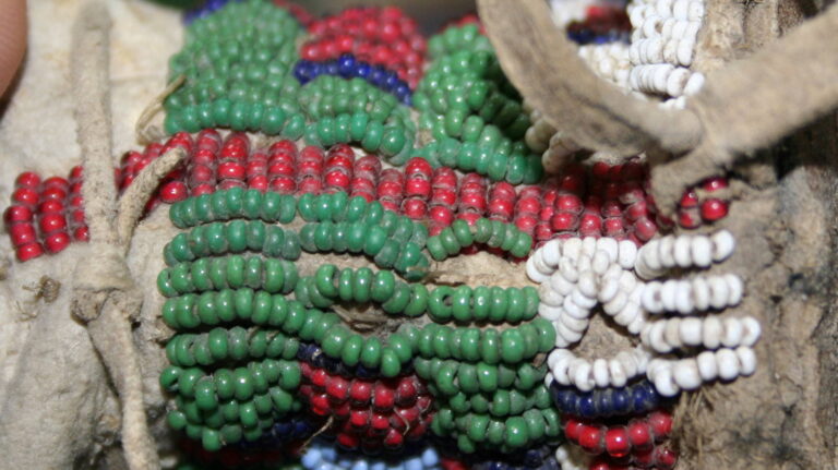 A Lakota moccasins detail. The white centers of some red white inside seed beads are clearly visible. A private collection.