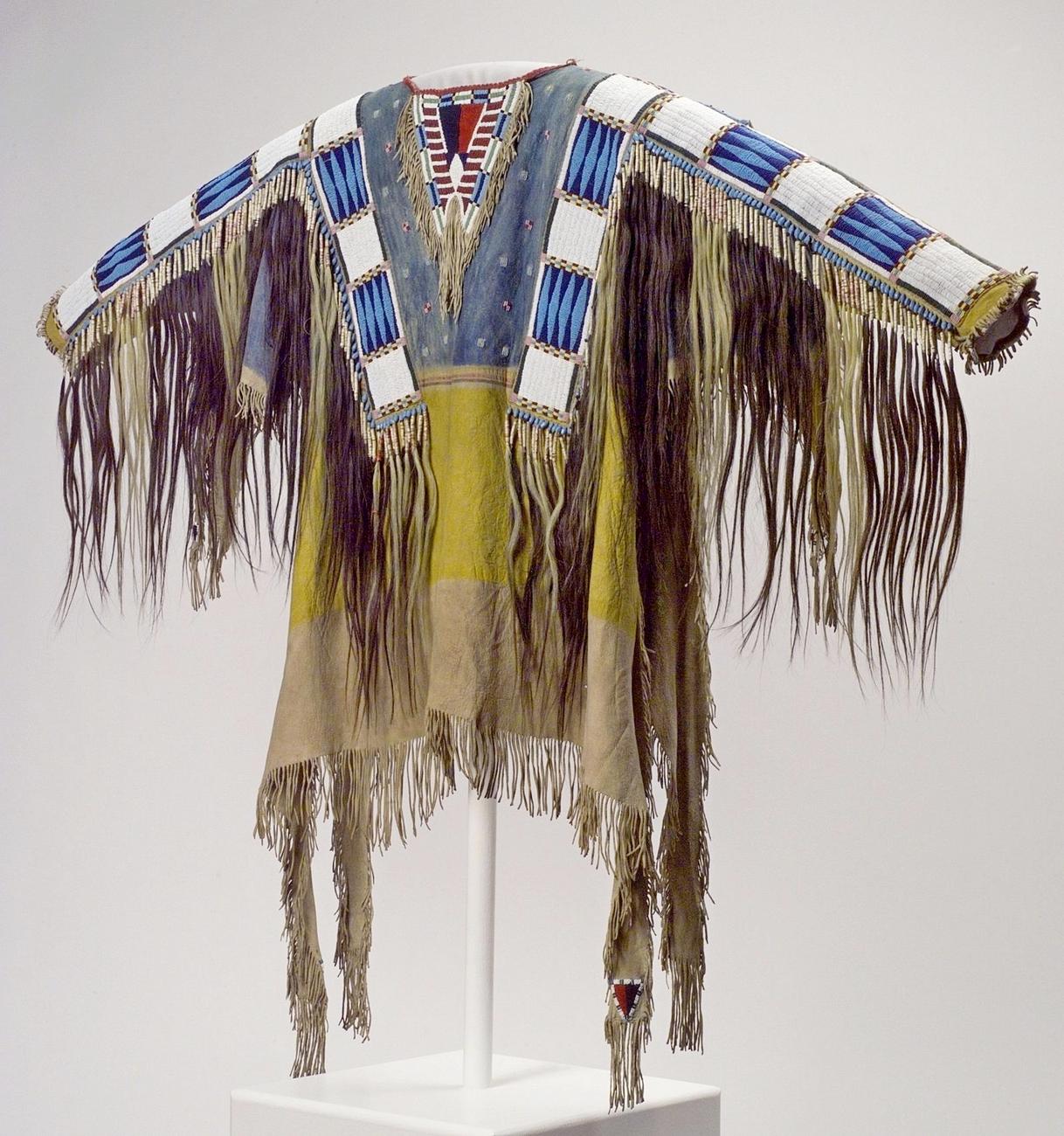 A war shirt that belonged to Oglala Sioux chief Red cloud. It is decorated with beaded strips and human hair scalp locks.