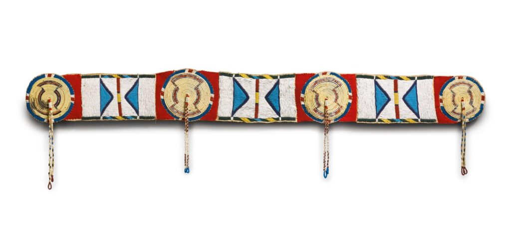 Embroidered decorative buffalo robe or blanket strip. The rosettes are embroidered using the QWHH technique. The rectangular panels are embroidered with seed beads. Sotheby’s auction.